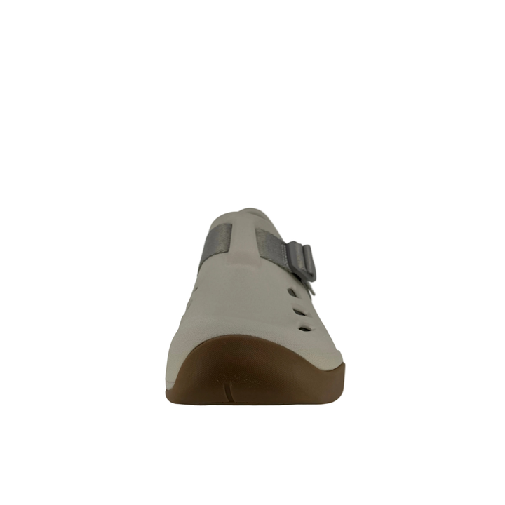 Beige shoe with brown sole on a white background